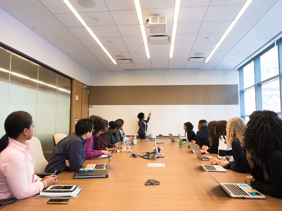 Investors seated around a boardroom table during a presentation